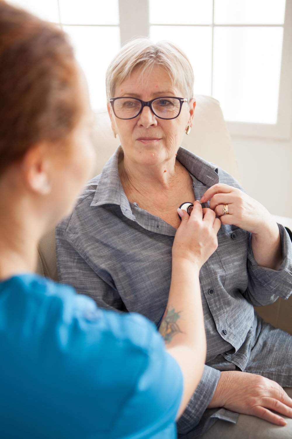 Elderly woman getting heart checked with Cancer, Heart Attack and Stroke Insurance