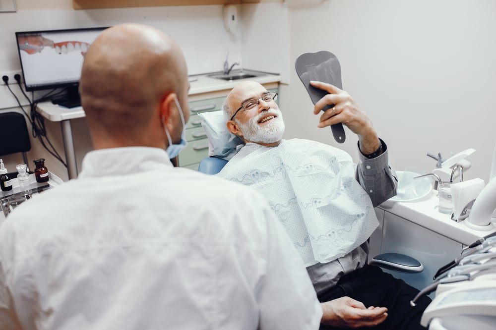 Elderly man at dentist with Dental Vision Hearing Insurance